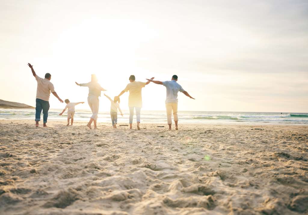 Family standing on a beach at sunset, representing preparation, protection, and confidence about the future.